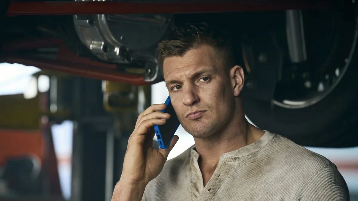 Former NFL star Rob Gronkowski holds a cellphone