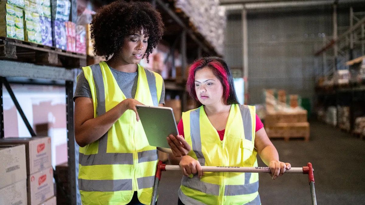 Young women working together in a warehouse.