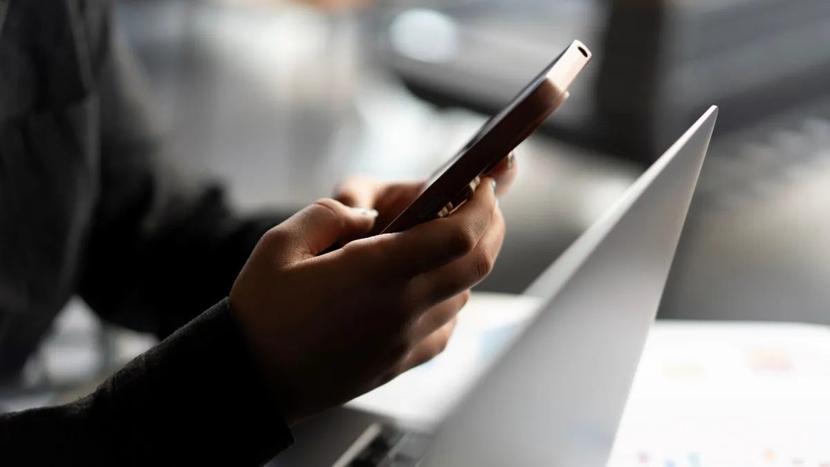 Close-up of young woman hand using smartphone