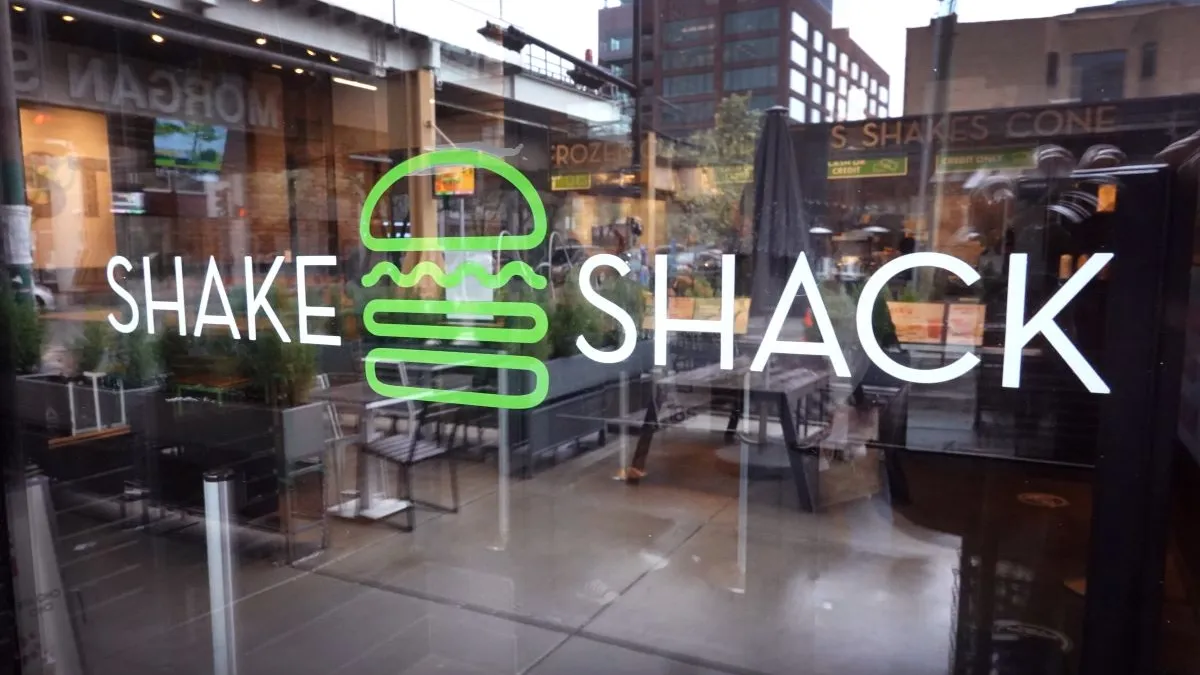 An image of the Shake Shack logo on a window.