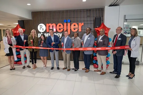 People at a ribbon cutting event.