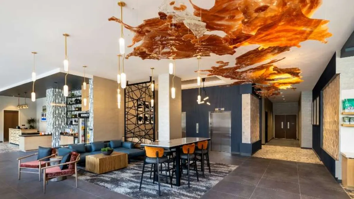 The lobby features bourbon-colored ceiling art.