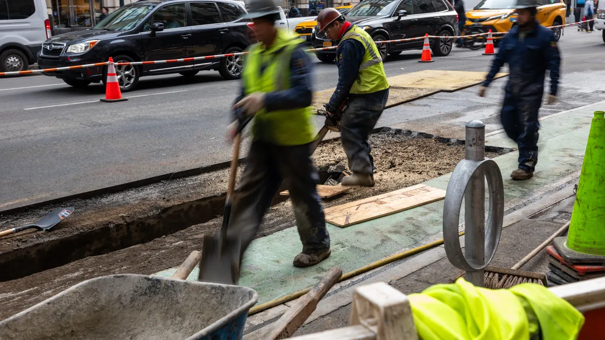 Construction workers at a construction site on a street in Manhattan