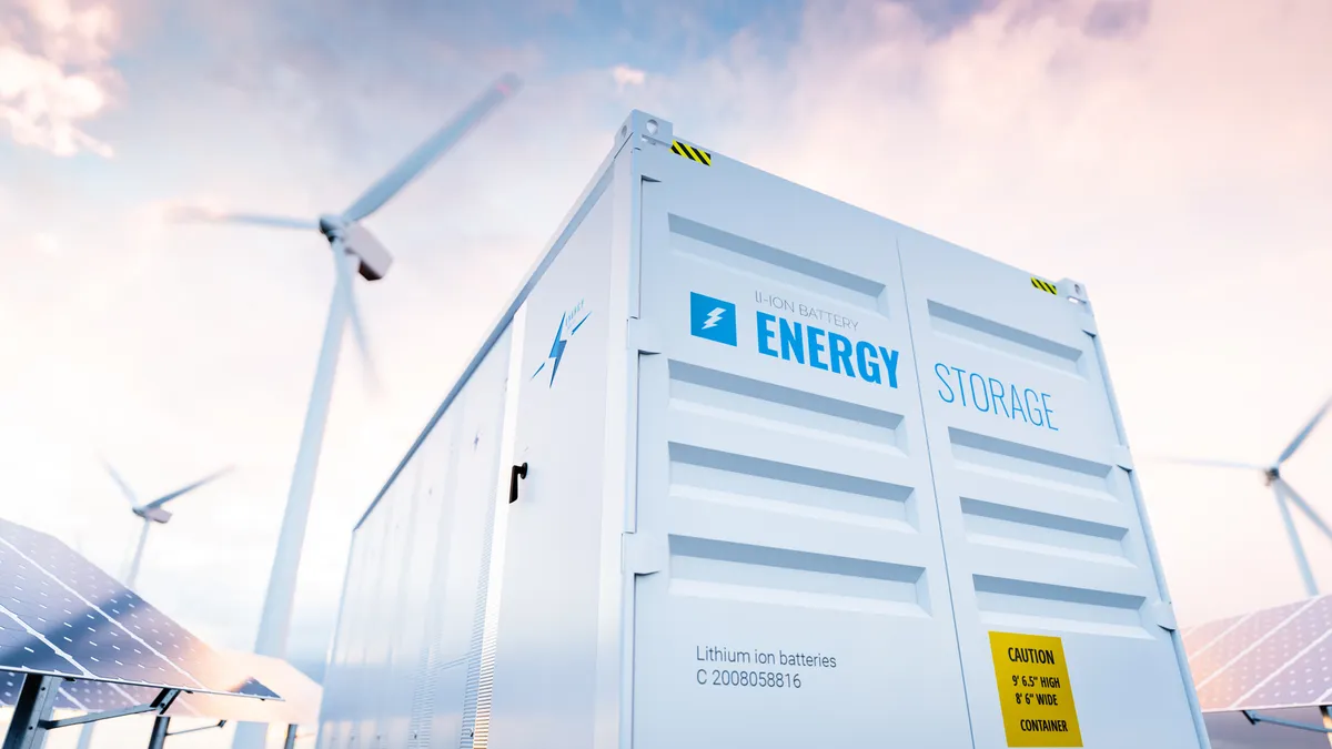 Conceptual image of a modern battery energy storage system with wind turbines and solar panel power plants in background. 3d rendering