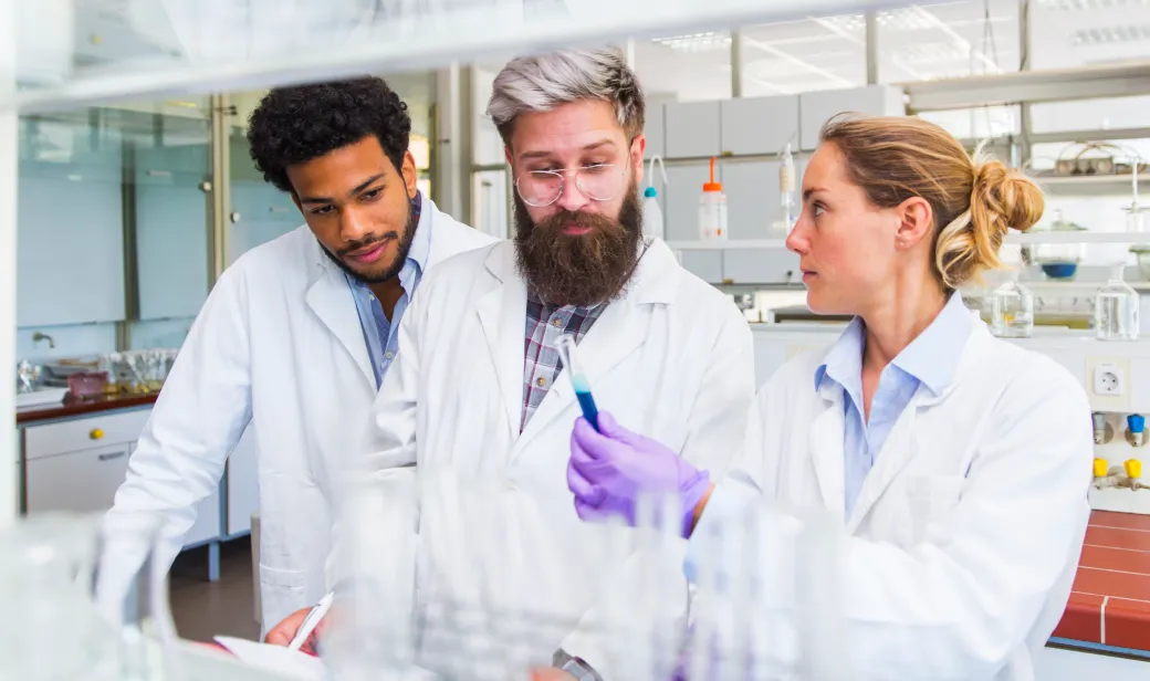 Group of scientists looking at clinical trial test results