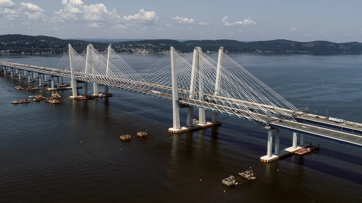 Overhead view of the silver Mario Cuomo Bridge over deep blue water.