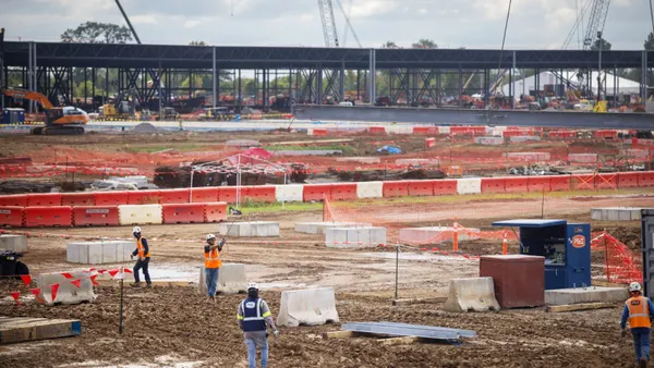 Construction workers at an industrial site.