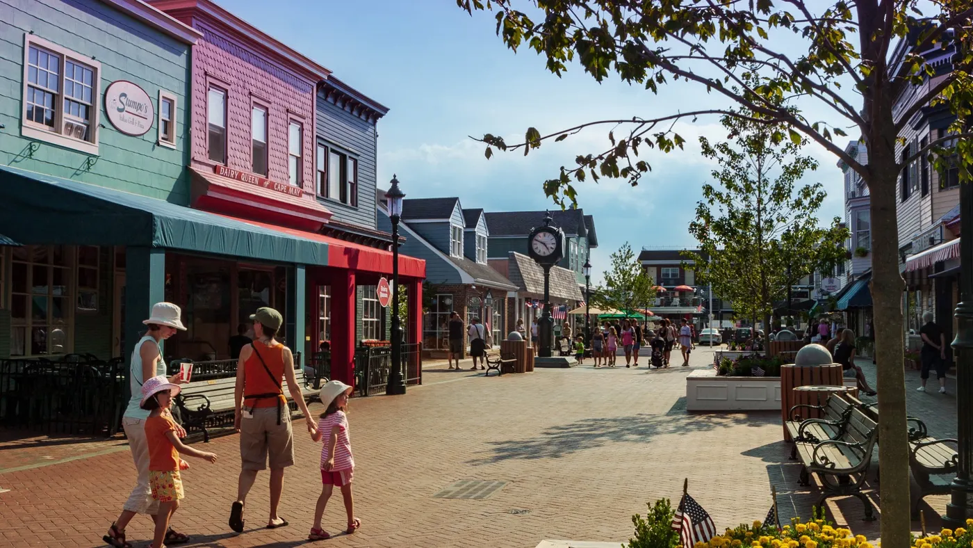 A family walking in a town square.