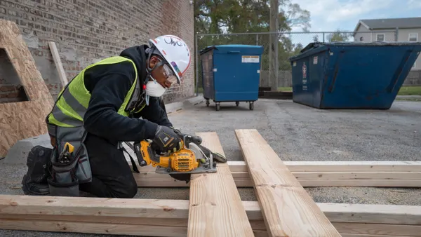 A trade worker works with construction materials