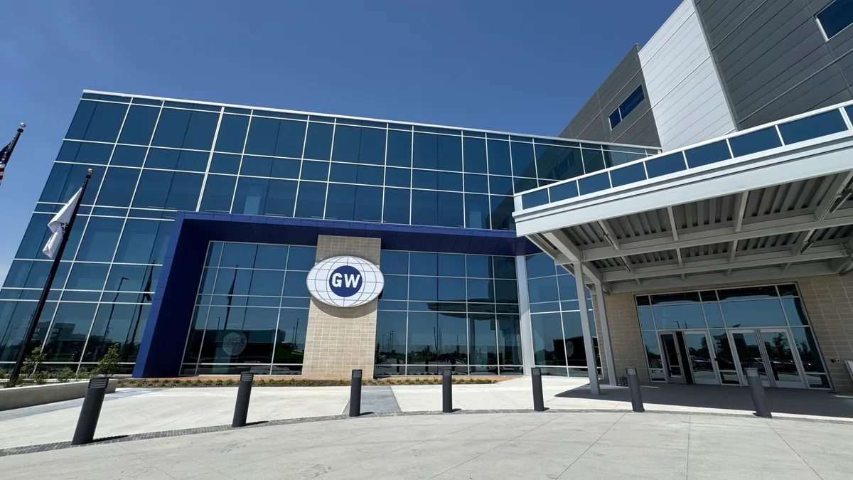 The front of an office building with windows and GlobalWafers blue and white logo sign in the center.