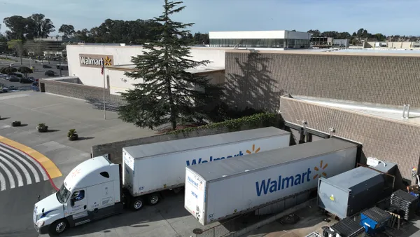 In an aerial view, trucks sit parked in front of a Walmart store on February 21, 2023 in Richmond, California.