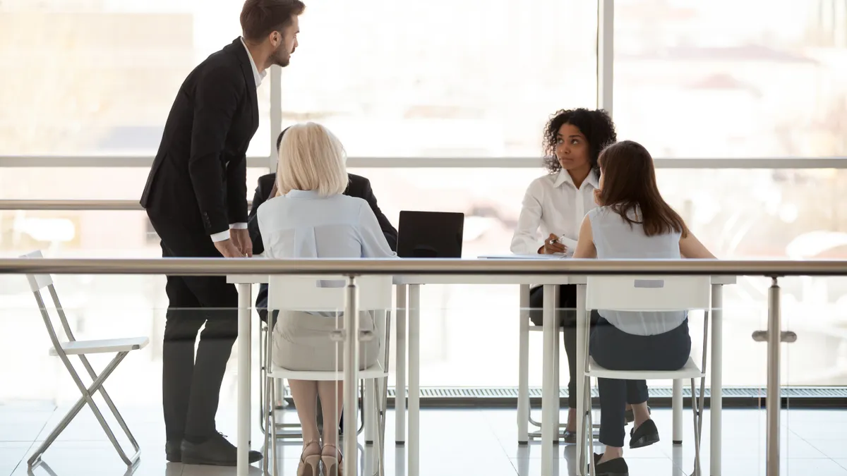 Employees discuss new project with boss holding business briefing