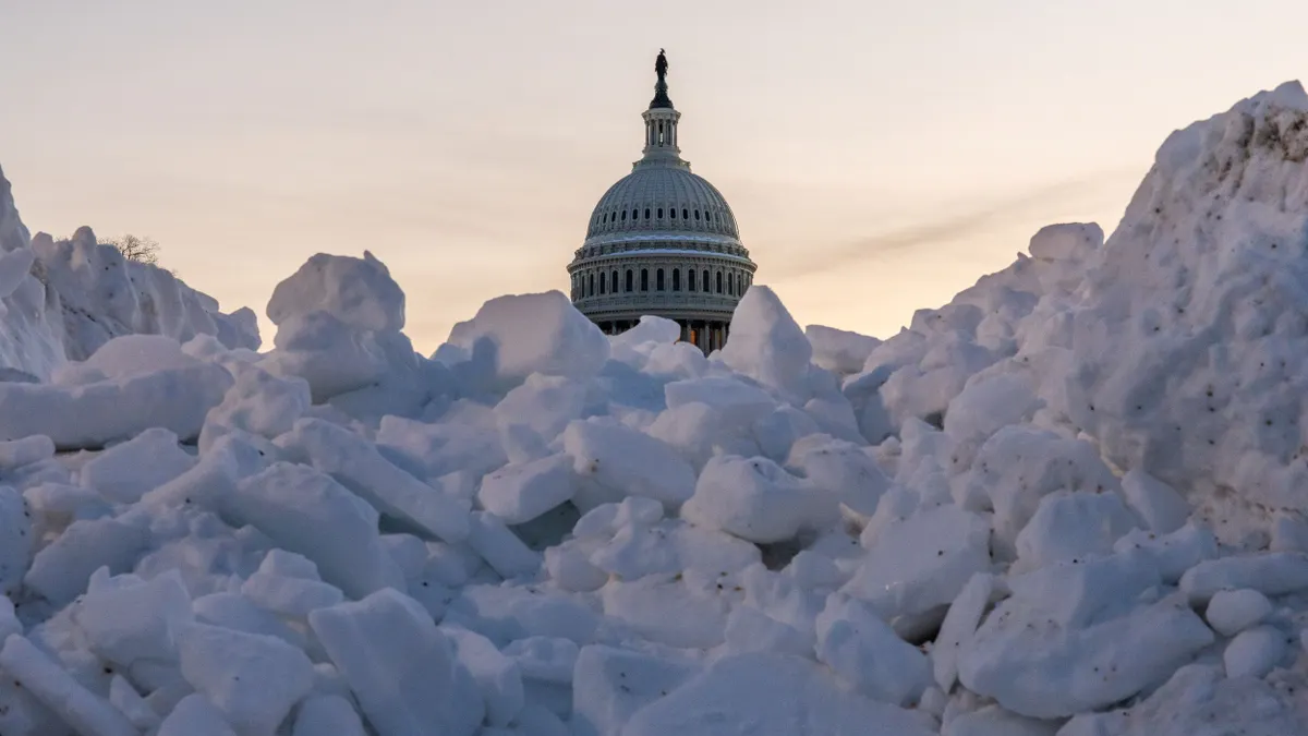 The United States Capitol surrounded by snow.