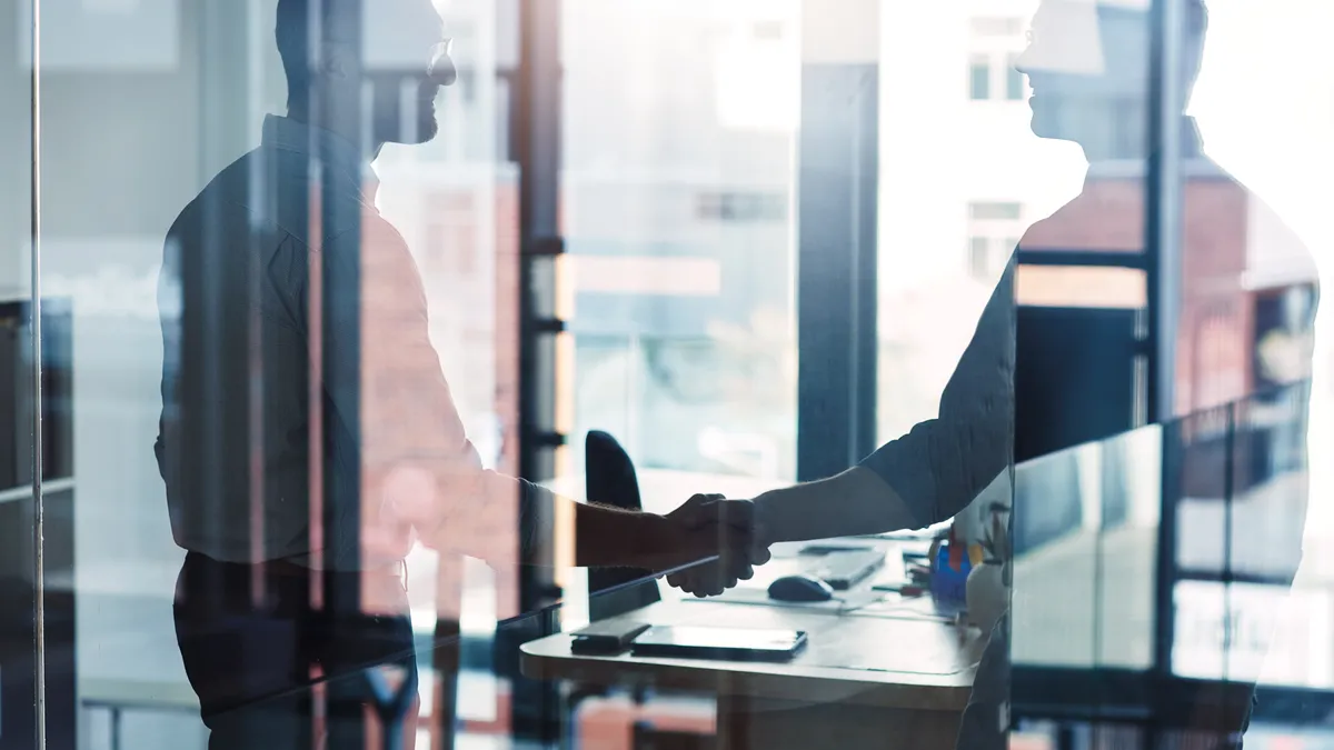 Shot of two businessmen shaking hands in an office