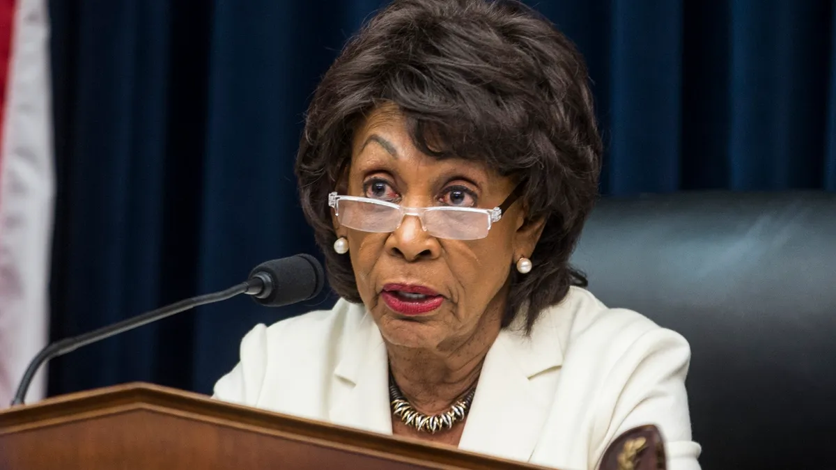 Congresswoman Maxine Waters speaks in front of a microphone in a Congressional session.