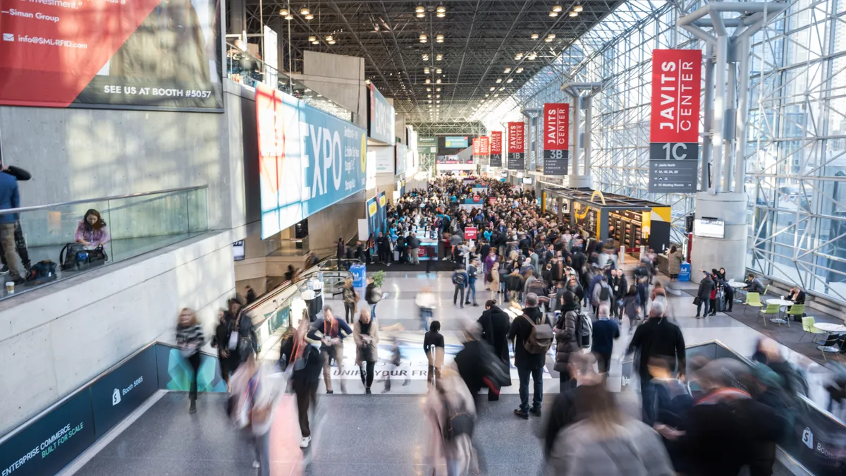 A crowd walks through the entrance to the 2024 NRF Big Show