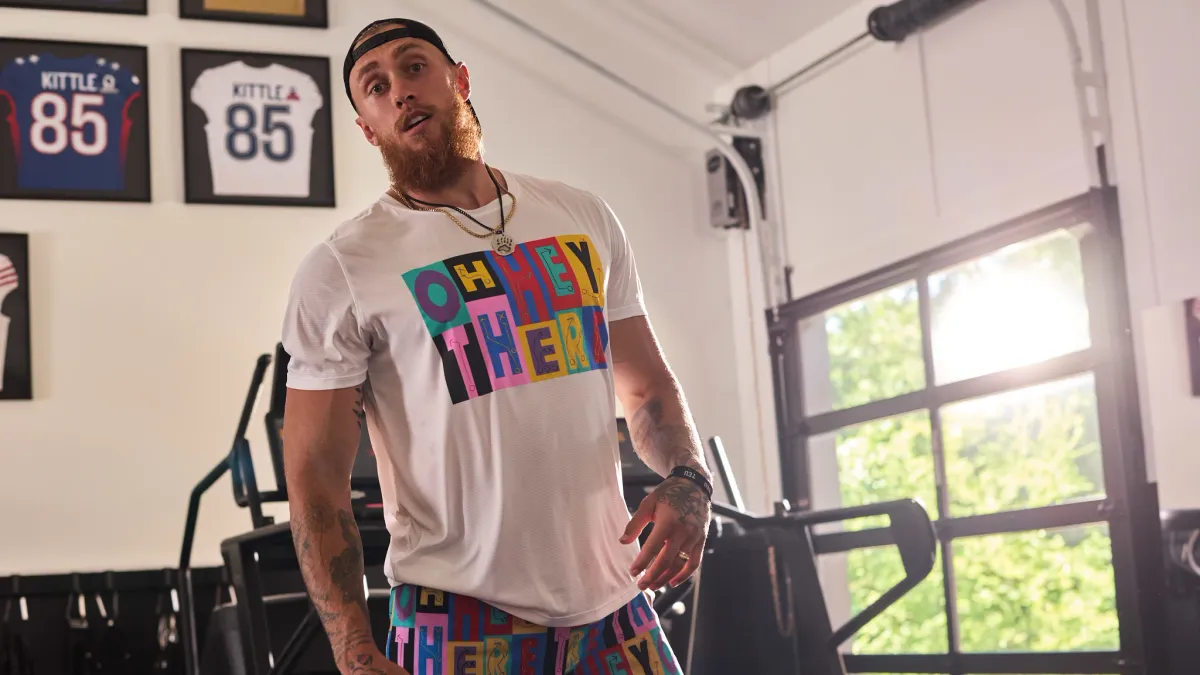 George Kittle, a football player, is seen in a gym wearing apparel from his collaboration with Chubbies.