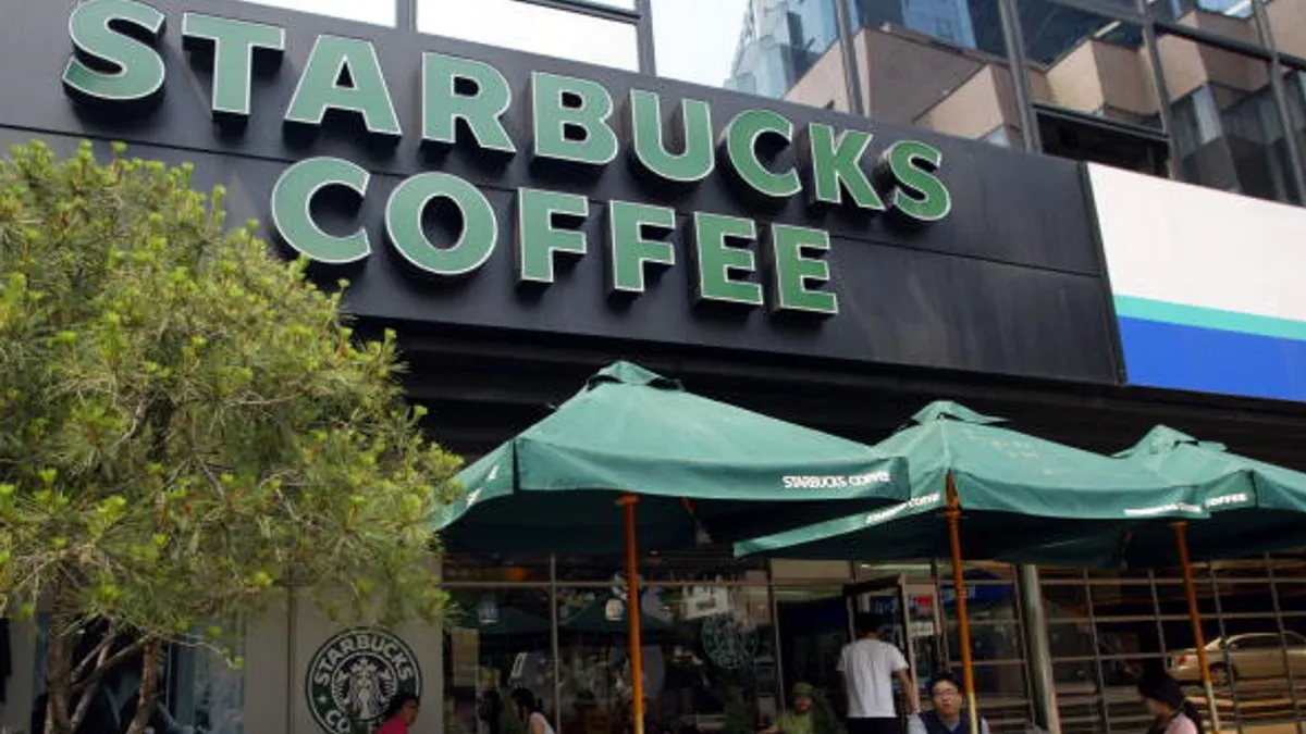 Customers sit outside a Starbucks coffee store on May 31, 2006 in Seoul, South Korea.