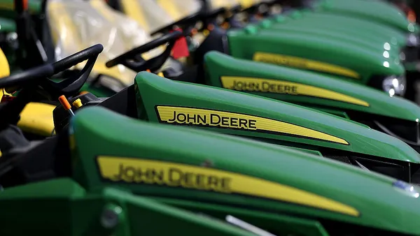 A line of green and yellow John Deere tractors