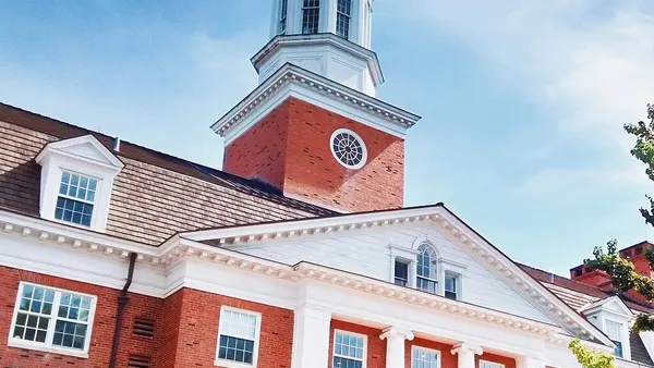 Brick building with columns and campanile.