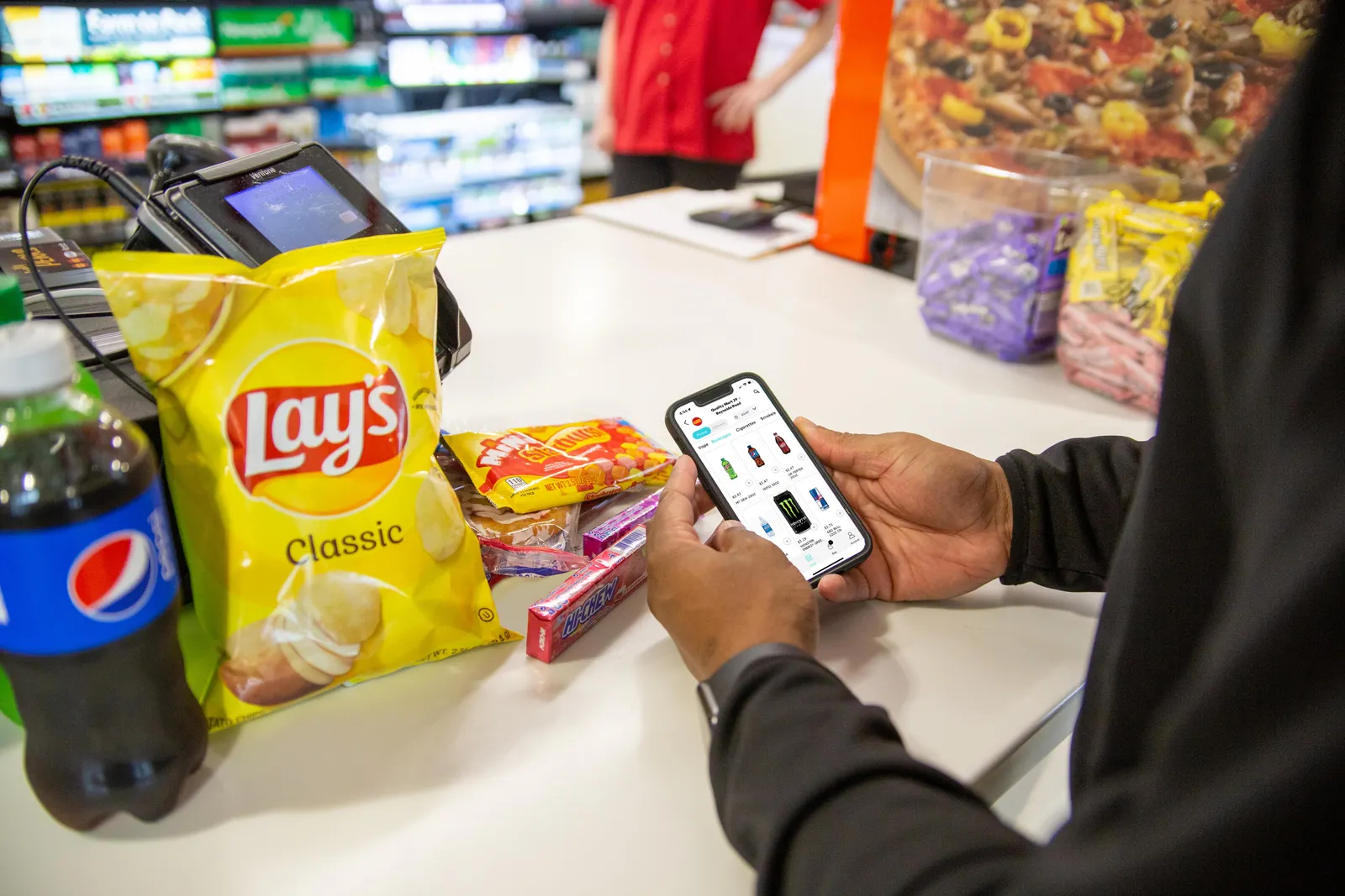 A photo of a person using the Quality Mart app to order ahead.