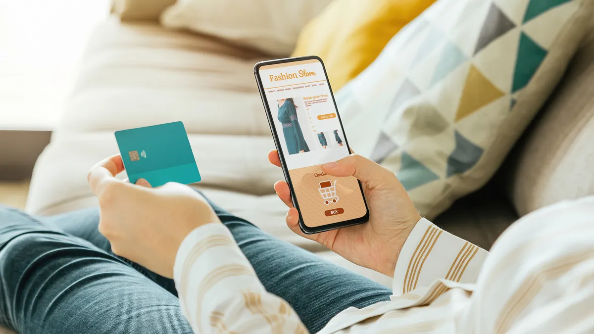 Woman shopping for clothes on her iPhone.