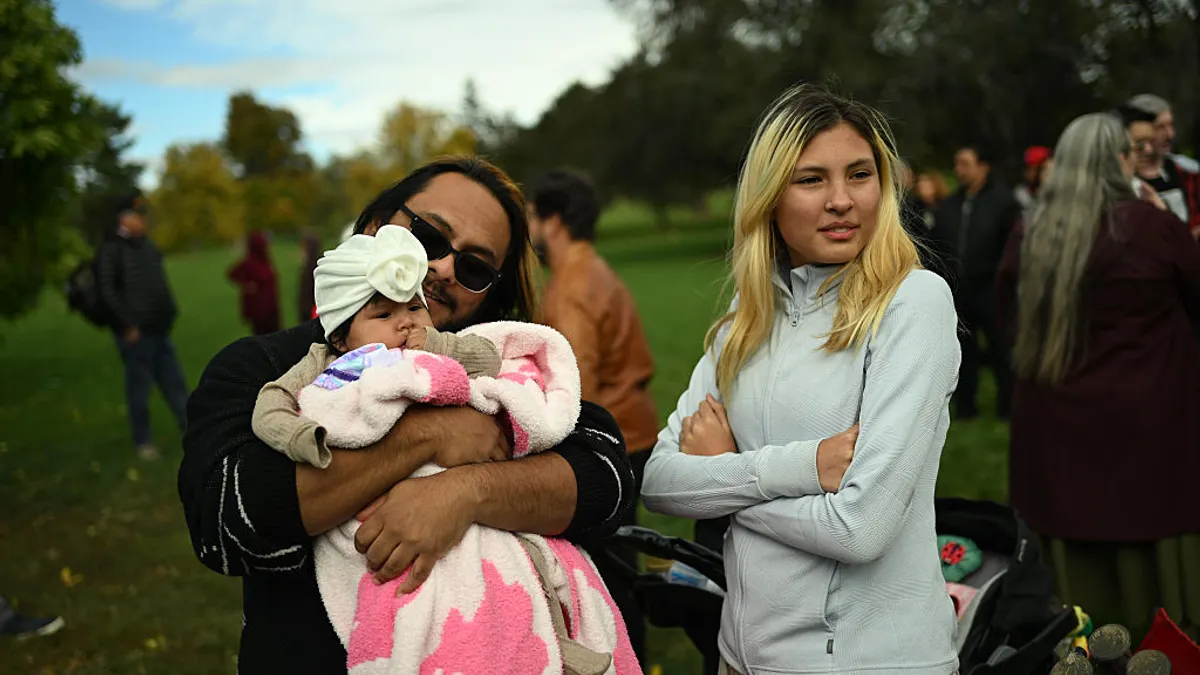 a man holds his baby daughter