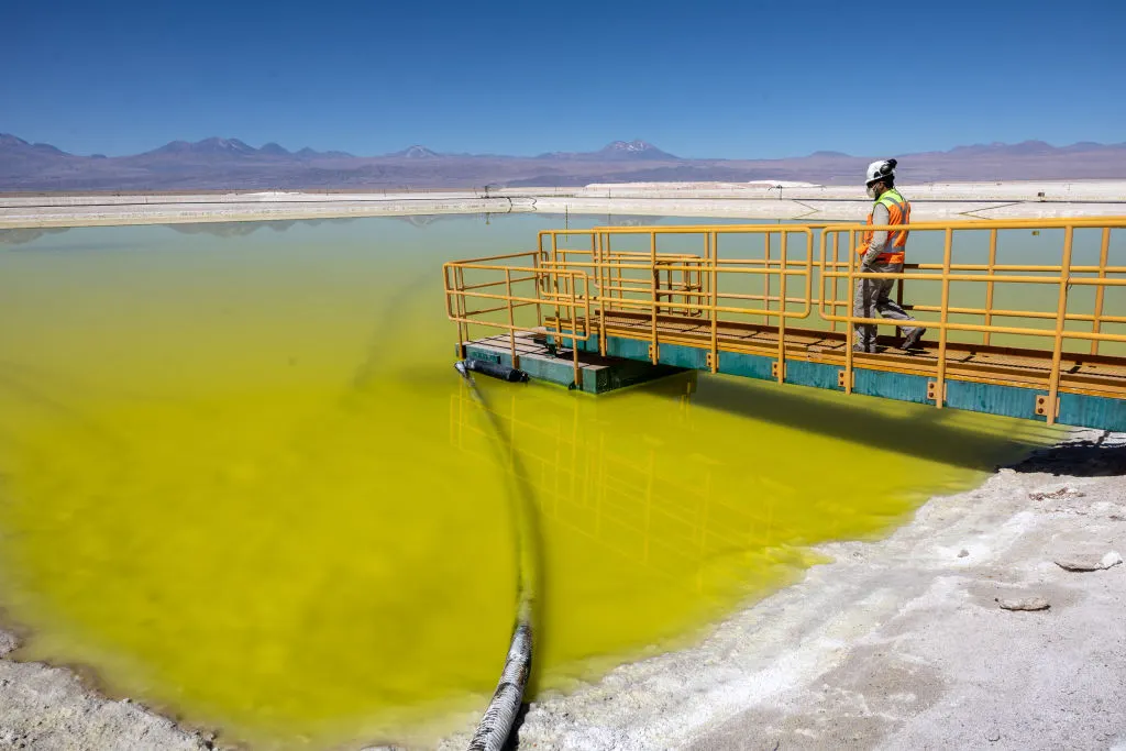 Man standing on a platform at a lihium mining operation in Chile