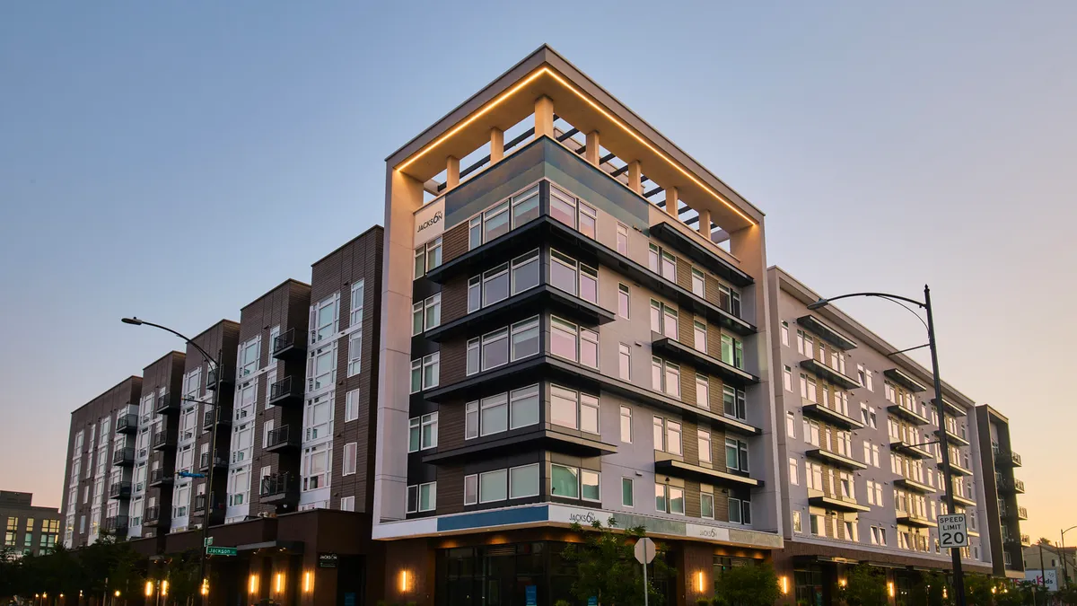 A five-story residential building at night.