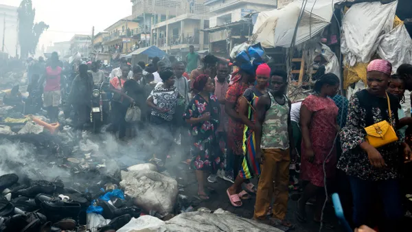 Shoppers looking at the damage caused by the fire at the Kantamanto Market.