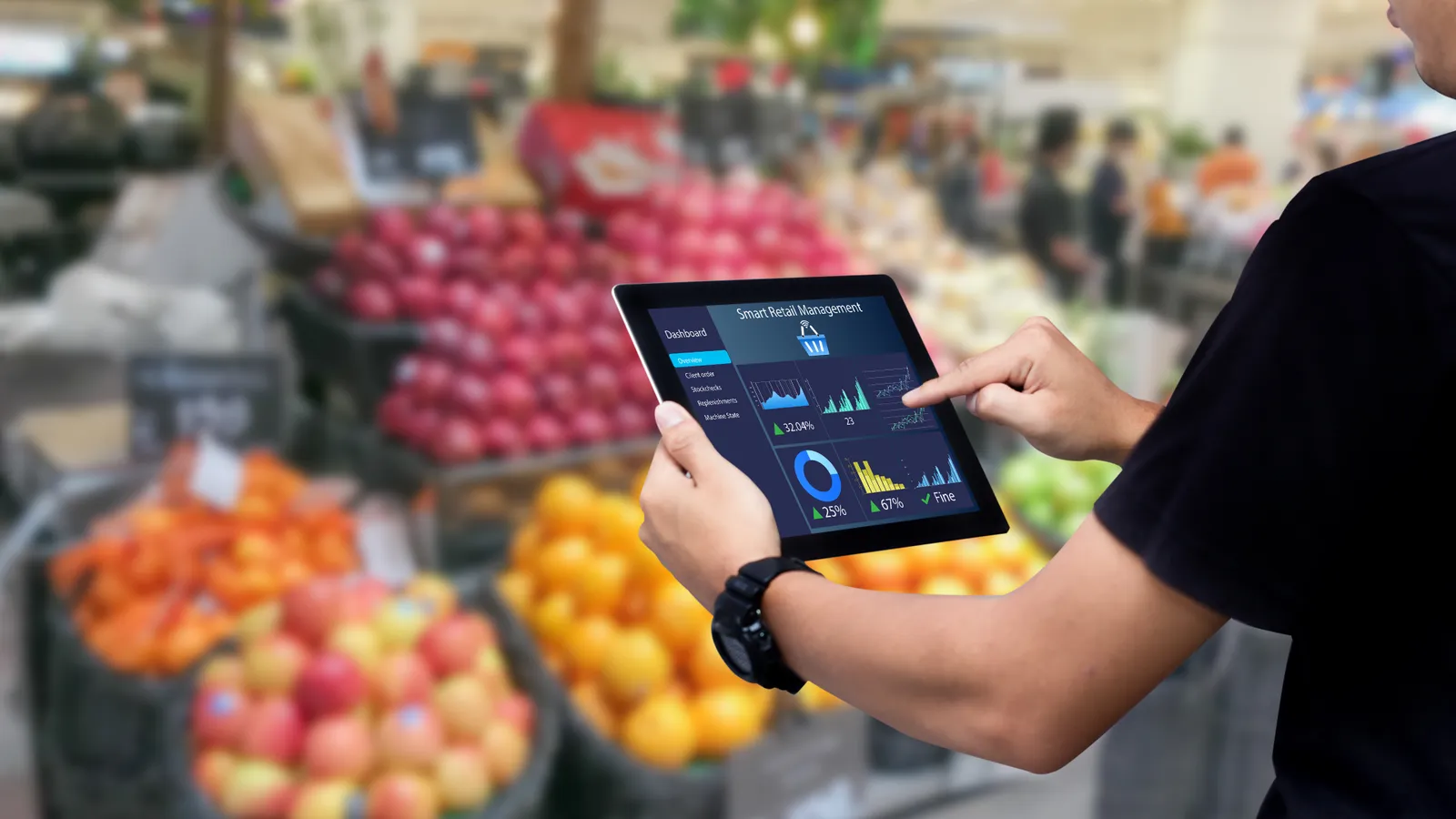 Worker hands holding tablet on blurred supermarket as background