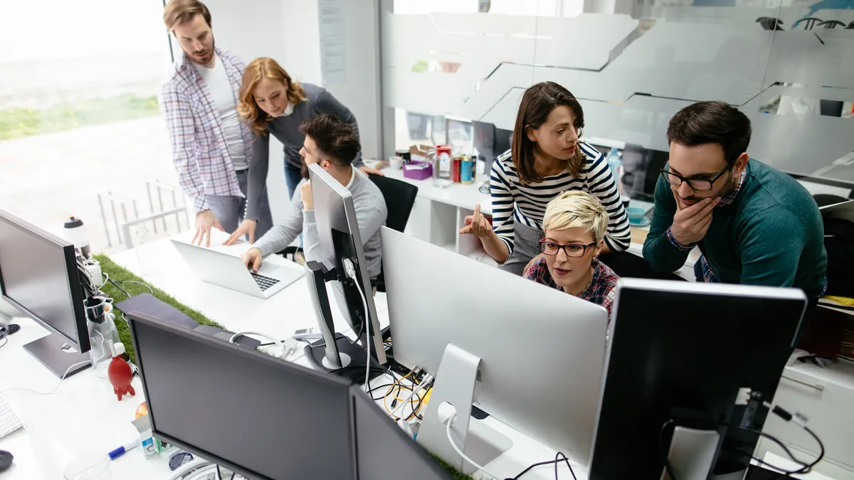 Web designers working in office on project together.