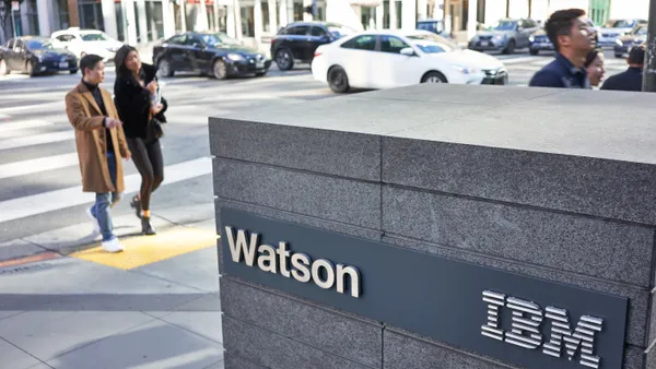 People walk past the IBM Watson sign outside the technology company's San Francisco office on February 8, 2020.