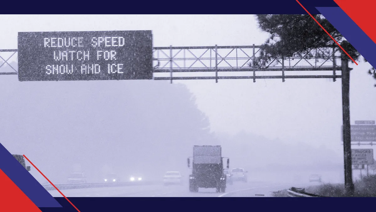 An electronic sign reads 'REDUCE SPEED WATCH FOR SNOW AND ICE' as vehicles move along Interstate 40 on January 17, 2018 in Morrisville, North Carolina