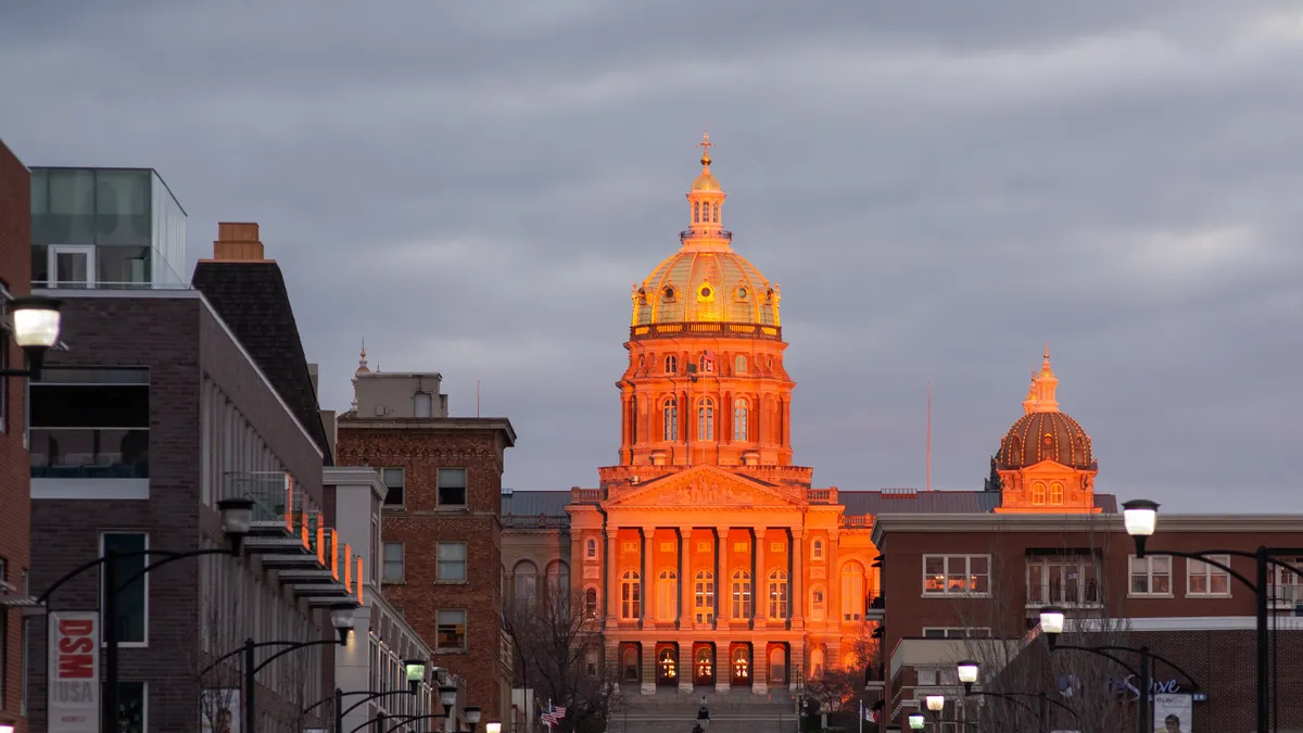 Iowa's state capital is lit by the sunset.