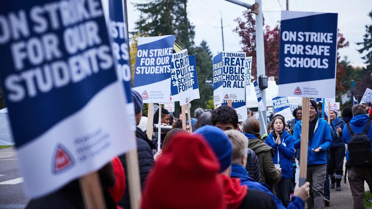 Portland teachers hold signs as they strike after failed negotiations with Portland Public Schools.