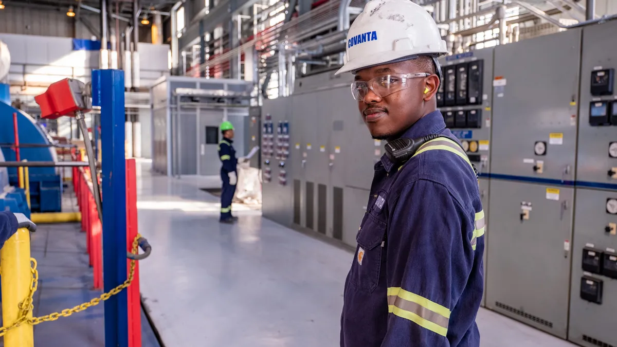 Man in hard hat standing in industrial facility