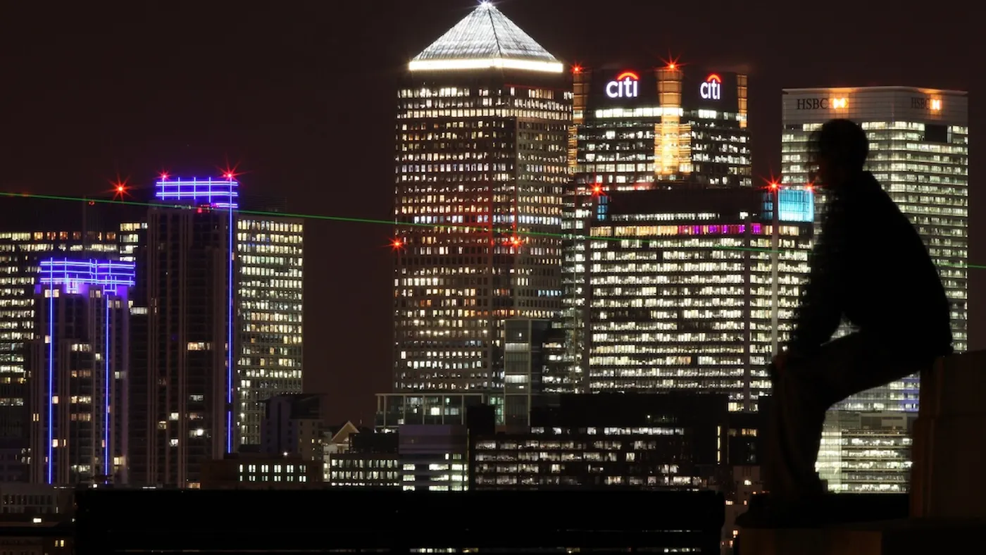A man views the skyscrapers in Canary Wharf on November 26, 2009 in London, England.