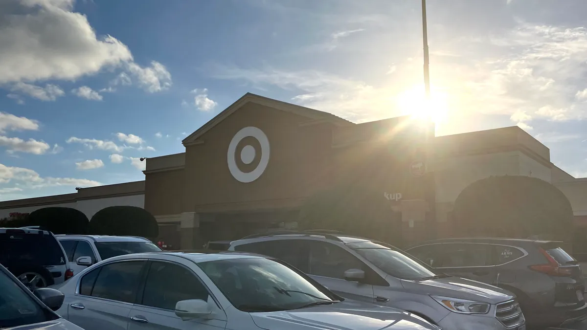 Target's bullseye logo on a storefront with cars in the parking lot