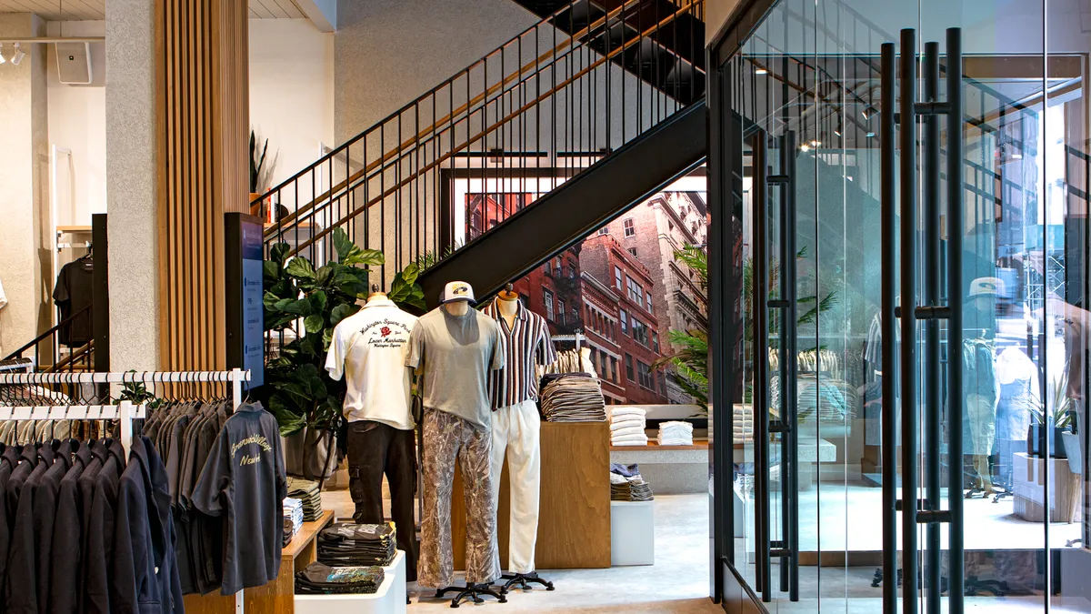 Interior store shot of mannequins in front of stairs.