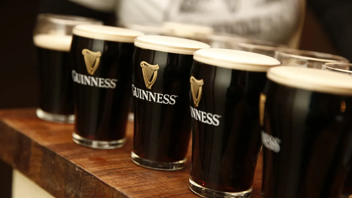 Row of Guinness logo glasses on a bar