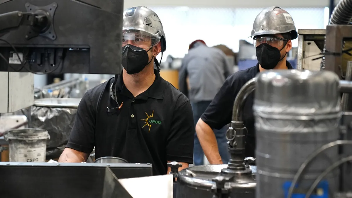 Urbix workers monitor graphite processing systems at the pilot facility in Arizona.