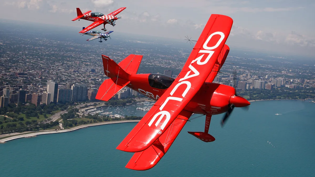 Two red biplanes with the Oracle logon on their wings fly over Lake Michigan in preparation for the Chicago Air and Water Show August 14, 2008 in Chicago, Illinois.