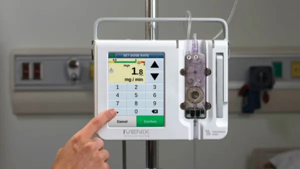 A hand points to a control screen.