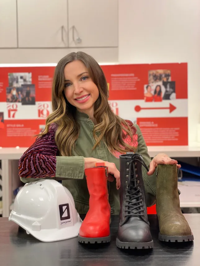 Headshot of Emily Soloby posing in front of work boots.