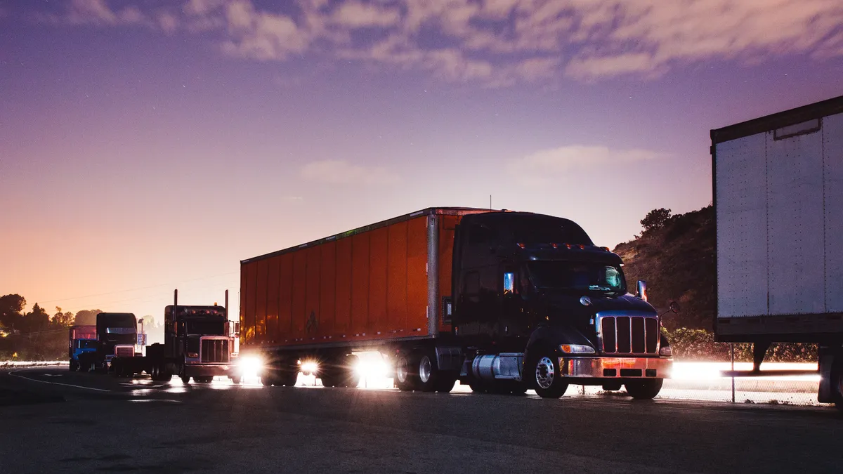 Trucks are parked along a highway.