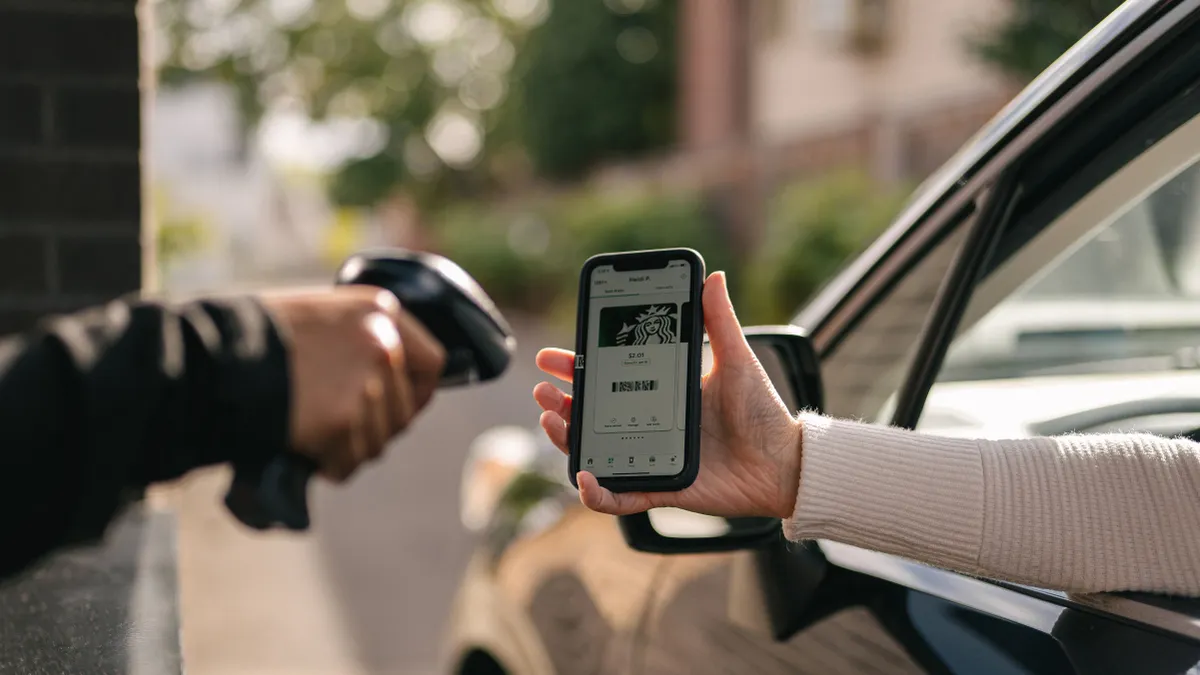 Customer uses Starbucks mobile app in drive-thru