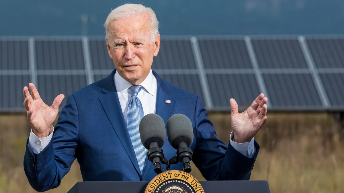 President Biden speaking in front of solar panels.