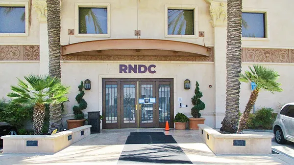 A building with Republic National Distributing Co.'s logo, RNDC, above a door.