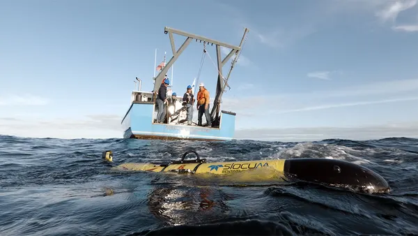A Teledyne Marine team on board a boat oversee the launch of a Slocum Sentinel glider into the Atlantic Ocean on Oct. 11, 2025.